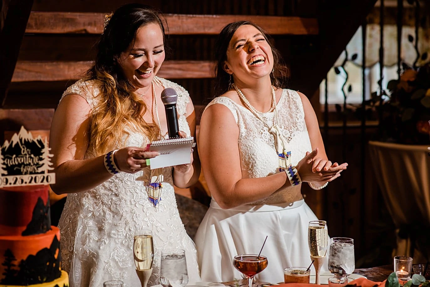 two brides give opening speech in barn at Deer Creek Valley Ranch same-sex wedding by Denver LGBT wedding photographer Jennie Crate