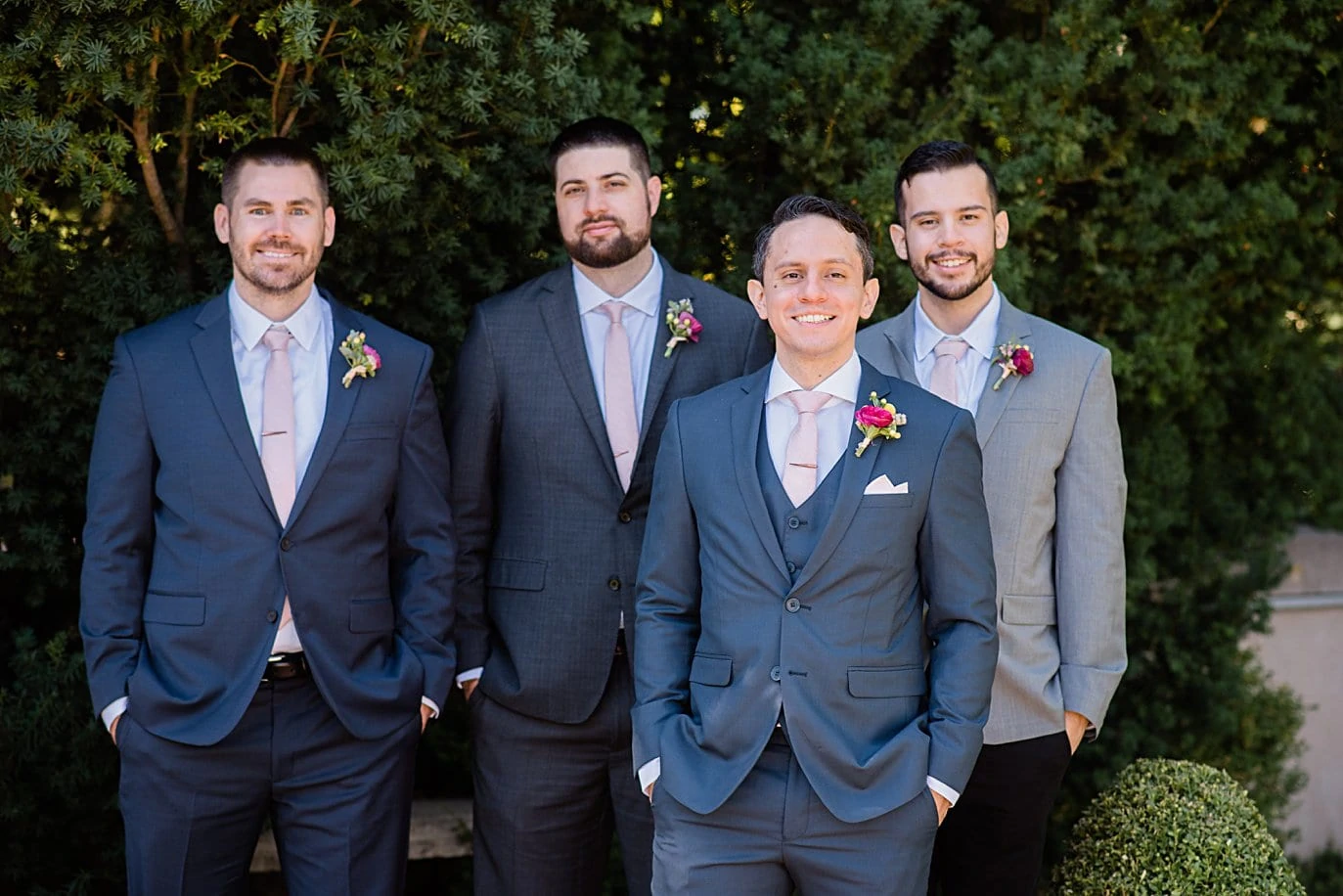 groom in blue suit with groomsmen in mismatched suites at Denver Botanic Gardens wedding by Denver wedding photographer Jennie Crate