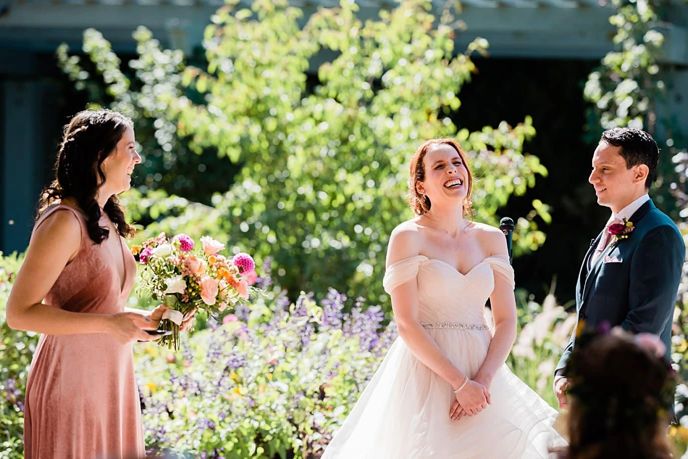 bride listens to maid of honor give speech during wedding ceremony at Denver Botanic Gardens microwedding by Denver wedding photographer Jennie Crate
