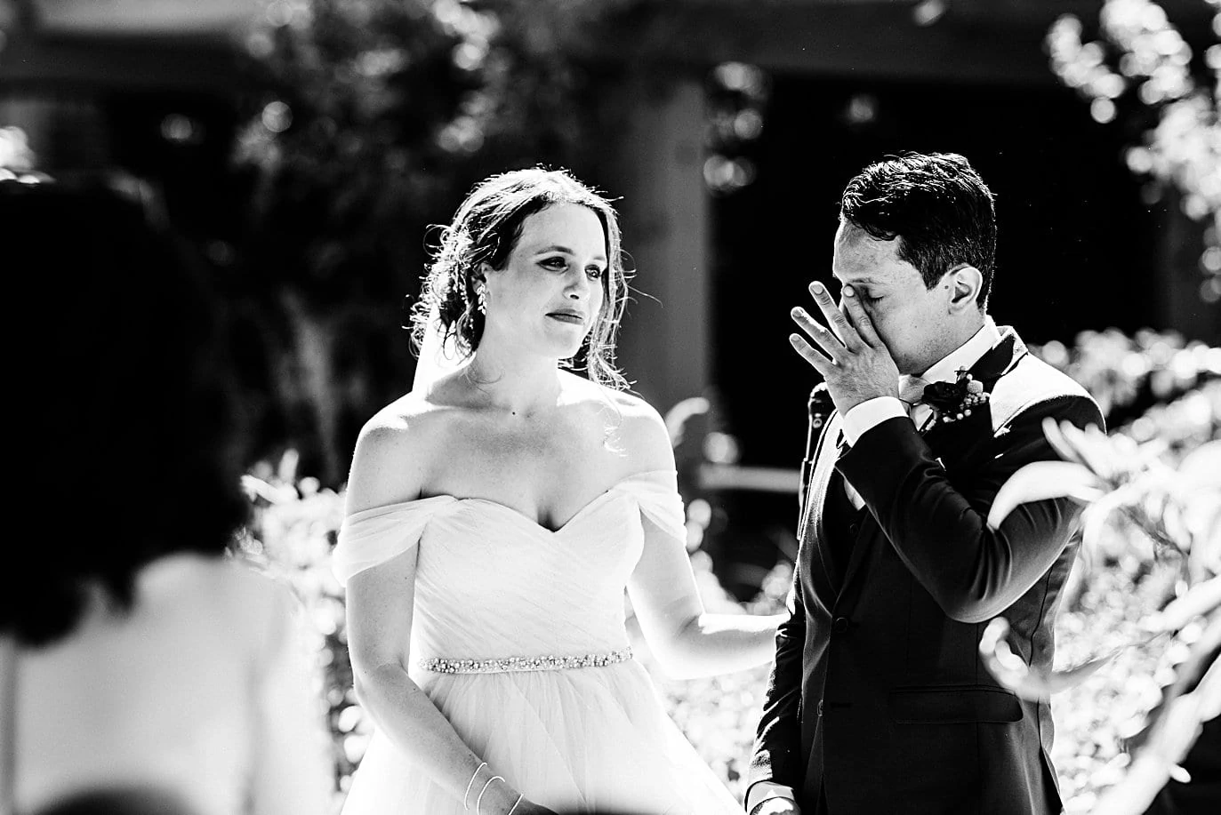 groom wipes away tears during self-solemnized wedding ceremony at Denver Botanic Gardens microwedding by Denver wedding photographer Jennie Crate