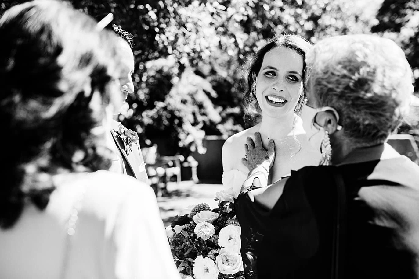 bride and groom embrace family after ceremony at Denver Botanic Gardens microwedding by Boulder wedding photographer Jennie Crate
