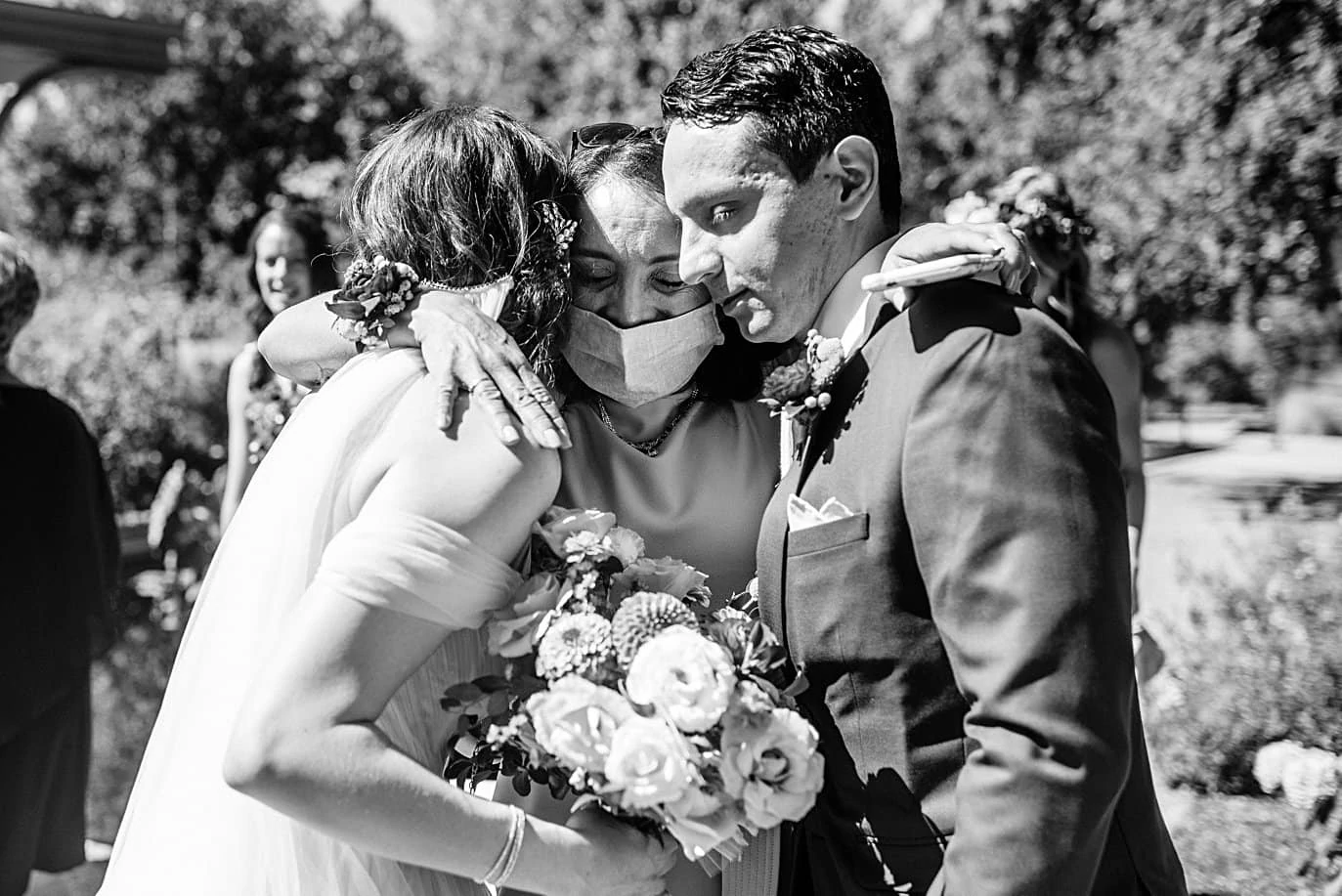 groom's mom hugs couple after ceremony at Denver Botanic Gardens microwedding by Boulder wedding photographer Jennie Crate