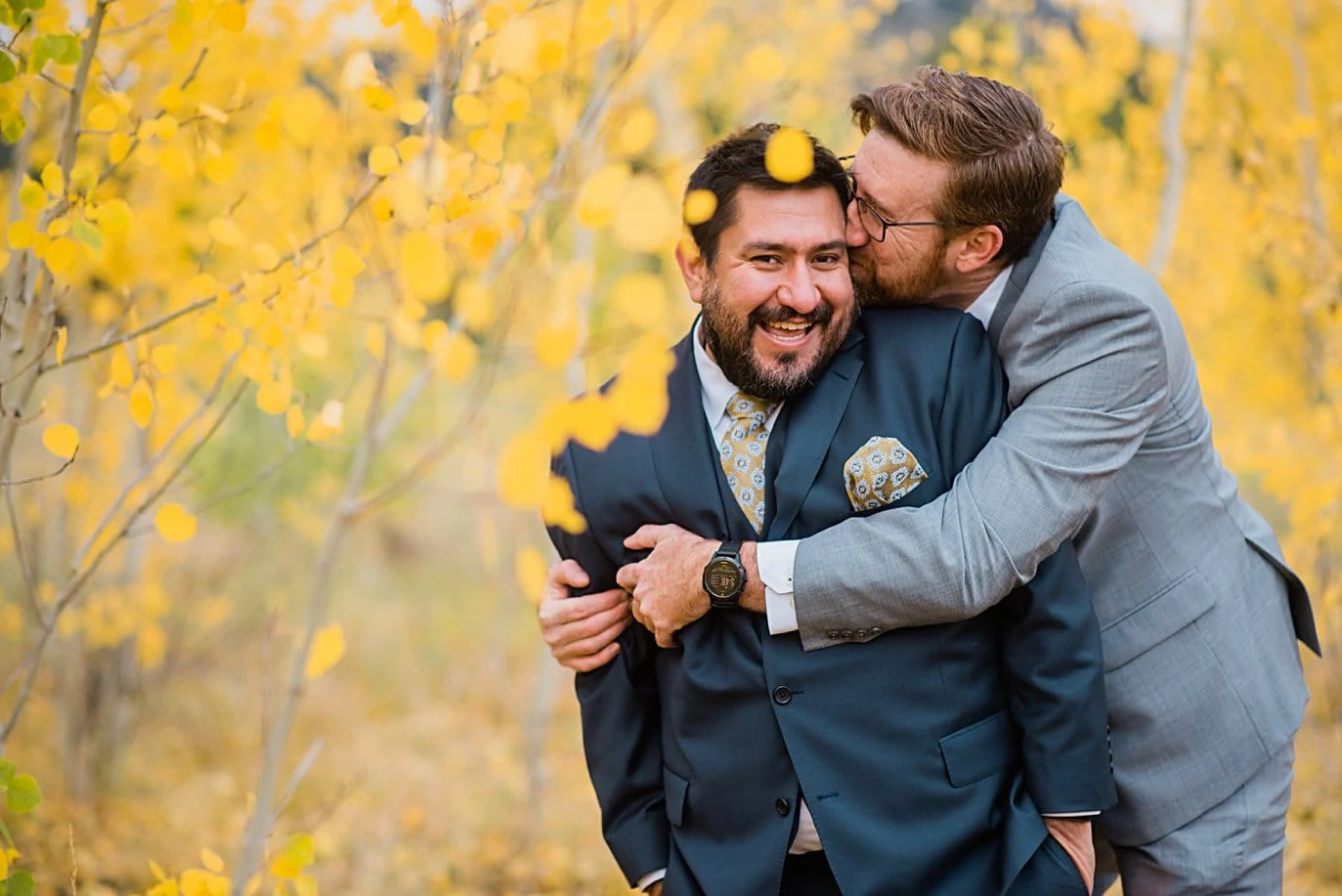 grooms cuddle during engagement session in Golden Gate Canyon by Colorado gay wedding photographer Jennie Crate