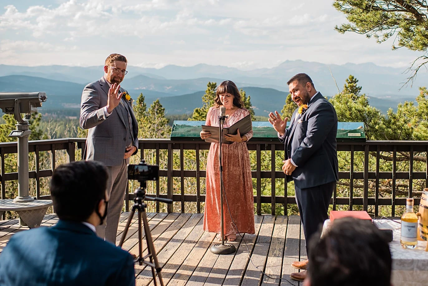 grooms wave to guest on zoom during intimate at Golden Gate Canyon microwedding by Golden wedding photographer Jennie Crate
