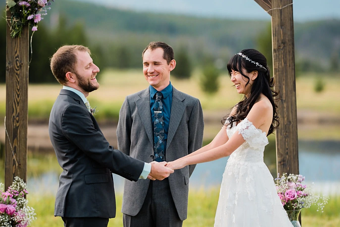 bride and groom laugh during vows at intimate Grand Lake wedding by Denver wedding photographer Jennie Crate