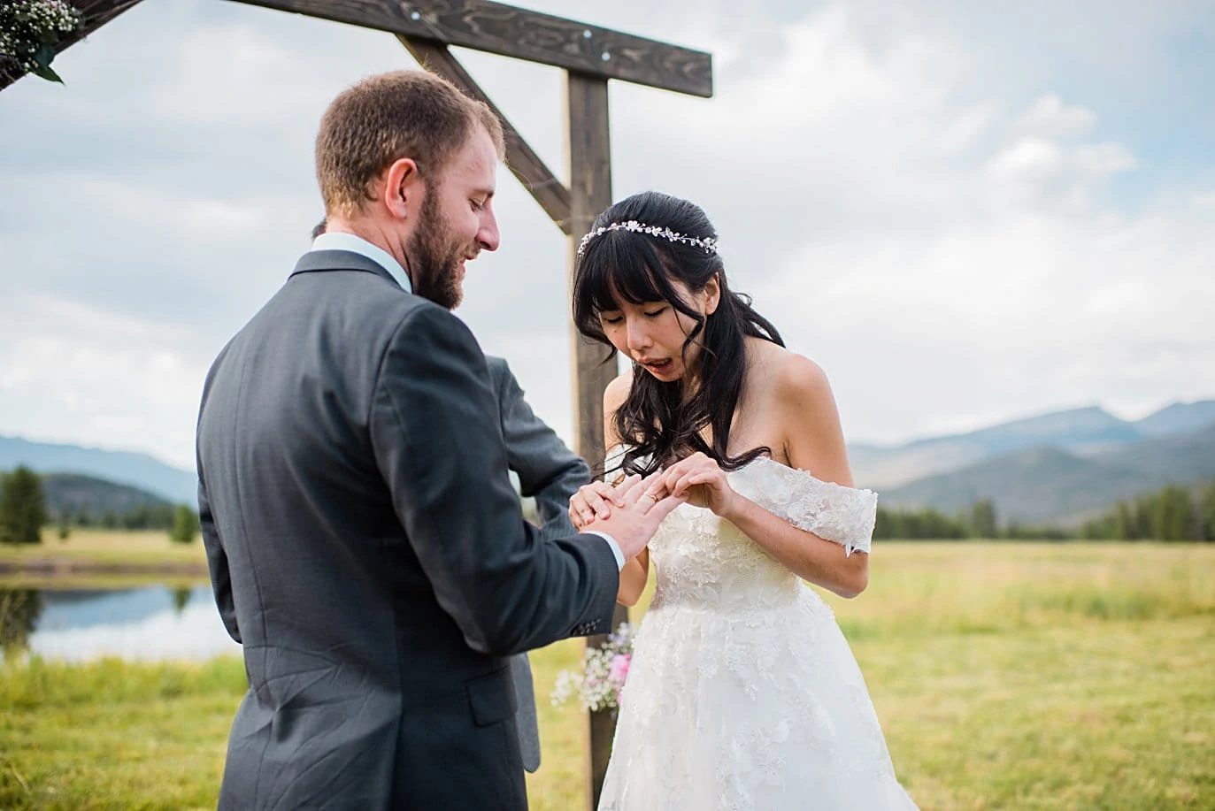 ring exchange in outdoor meadow ceremony at intimate Grand Lake wedding by Estes Park wedding photographer Jennie Crate