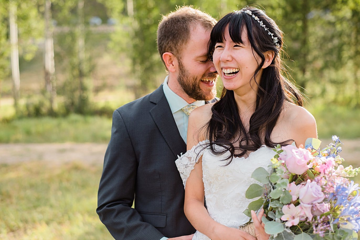 bride and groom laughing at intimate Grand Lake wedding by Estes Park wedding photographer Jennie Crate