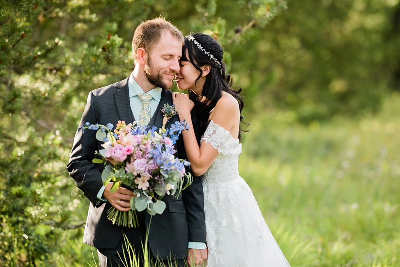 bride and groom with wildflower bouquet at intimate Grand Lake wedding by Estes Park wedding photographer Jennie Crate
