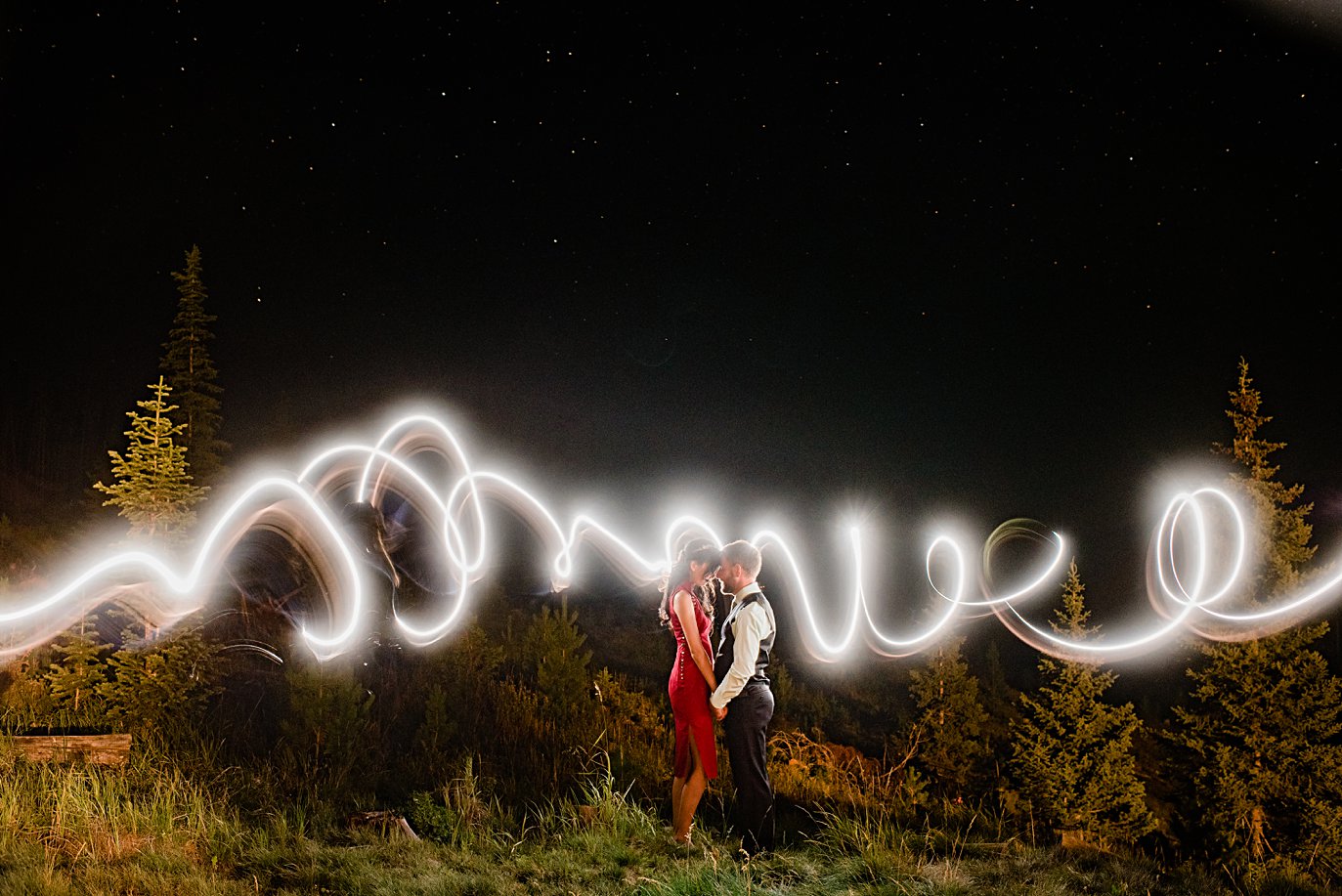 night portrait with light painting at intimate Grand Lake wedding by Boulder wedding photographer Jennie Crate