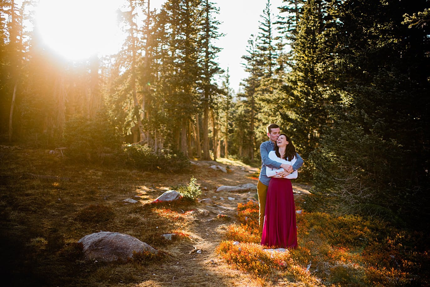 bride and groom cuddle at sunset engagement hike to Mitchell Lake by Denver engagement photographer Jennie Crate