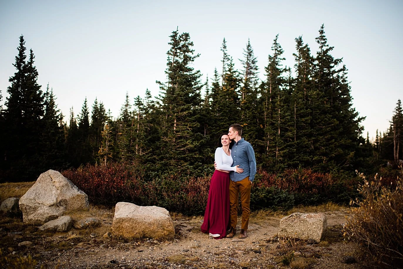 sunset photo in the trees at Brainard lake engagement session by Boulder wedding photographer Jennie Crate