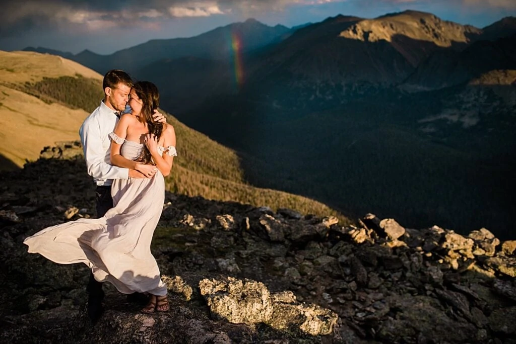 portrait with rainbow at sunset at top of trail ridge road during engagement session by Estes Park engagement photographer Jennie Crate