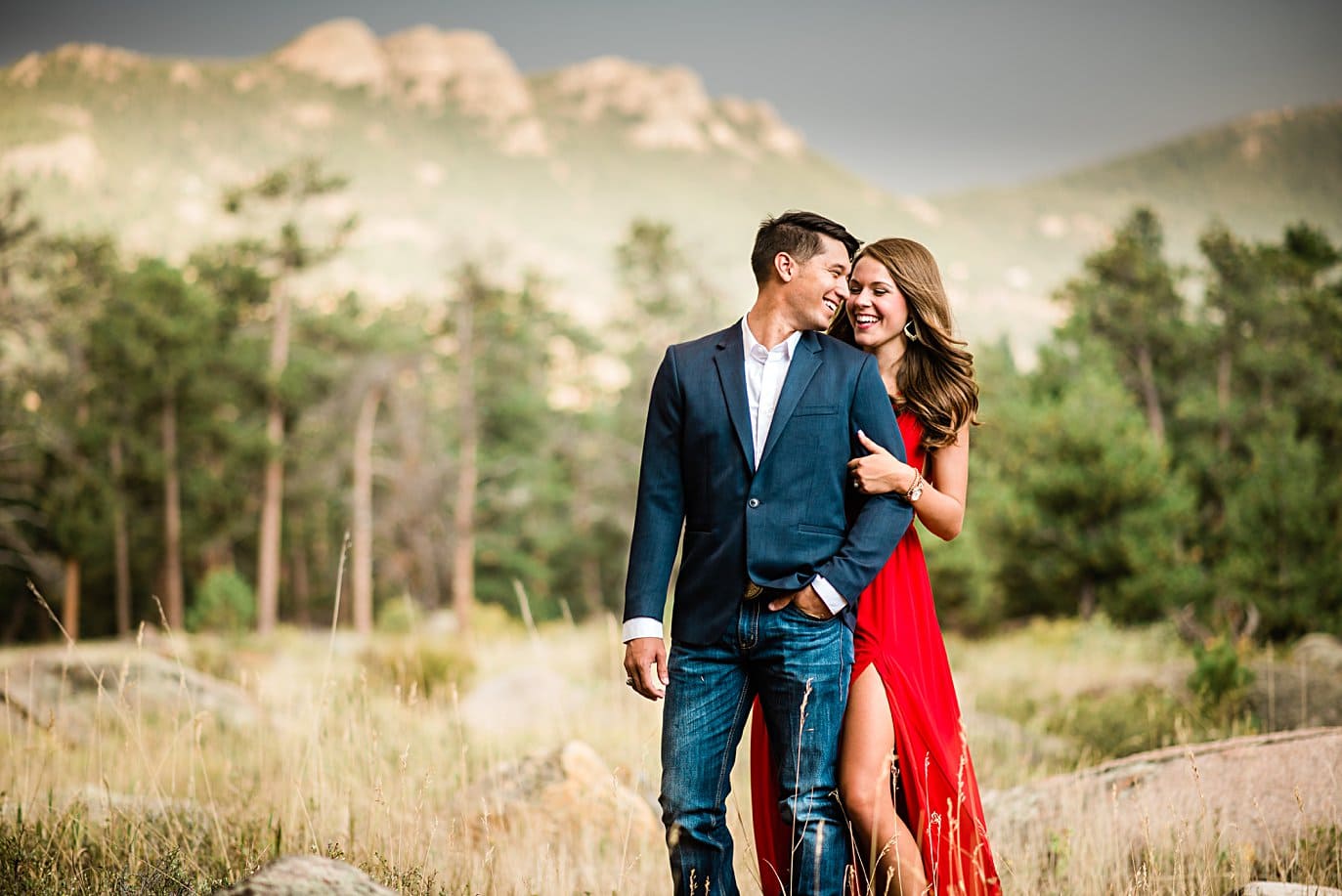 engaged couple in blue suit jacket and red formal dress at Rocky Mountain National Park engagement by Lyons engagement photographer Jennie Crate