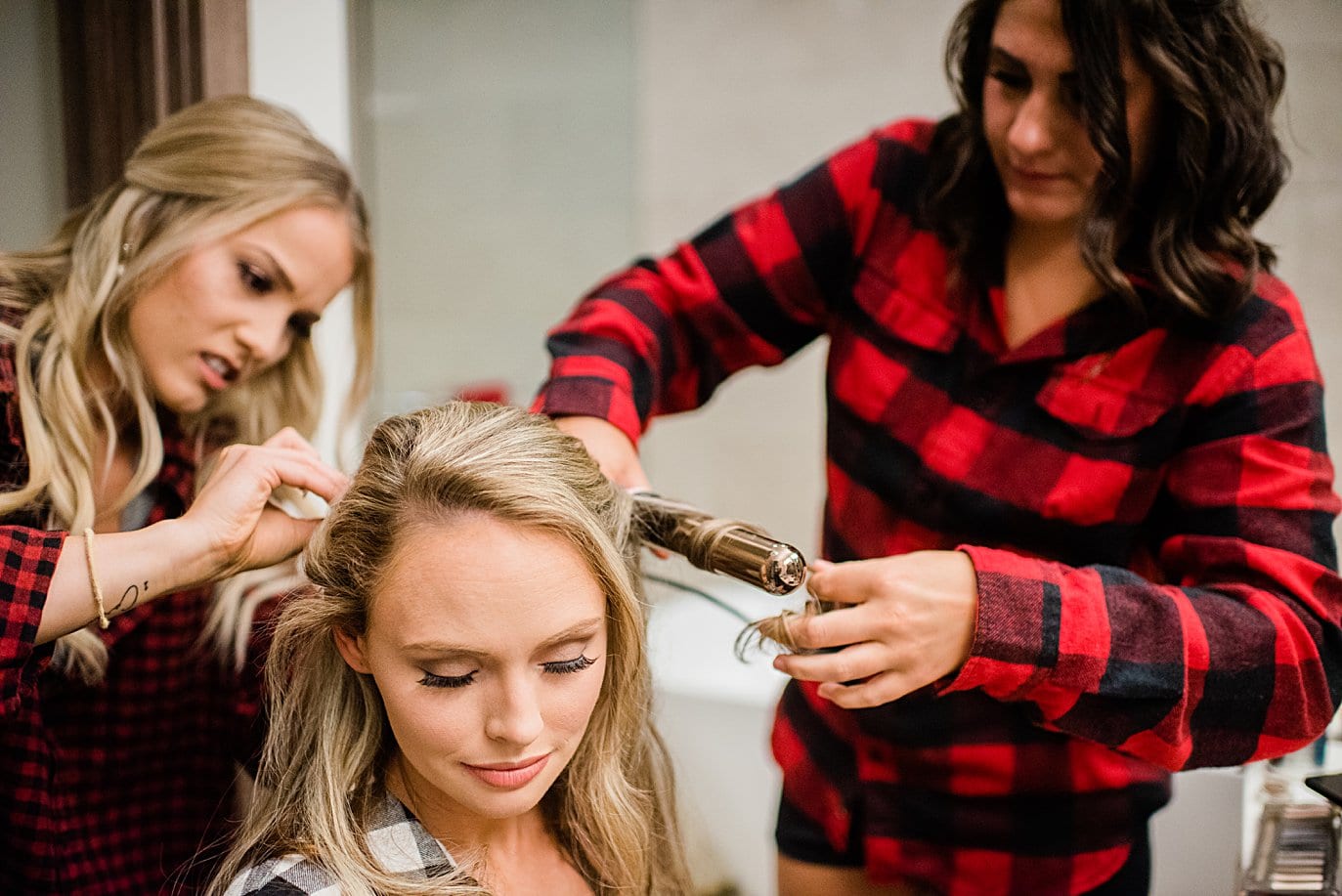 bride getting hair curled and styled by bridesmaids at Larkspur Vail Wedding by Vail Wedding photographer Jennie Crate