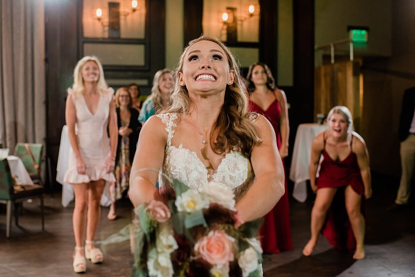 bride bouquet toss at Vail Manor Lodge wedding by Aspen wedding photographer Jennie Crate