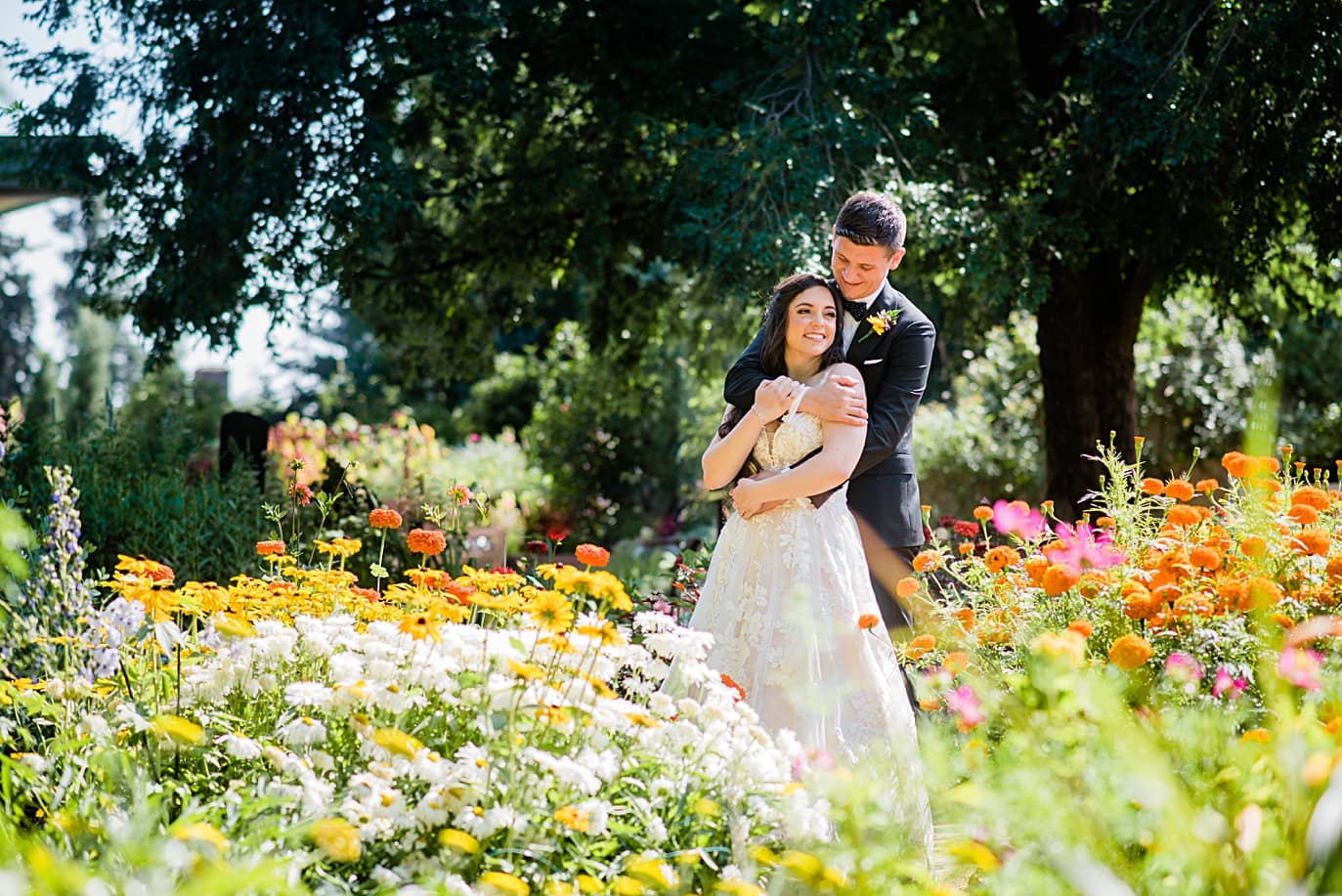 bride and groom in flowers in mid-summer at the Denver Botanic Gardens