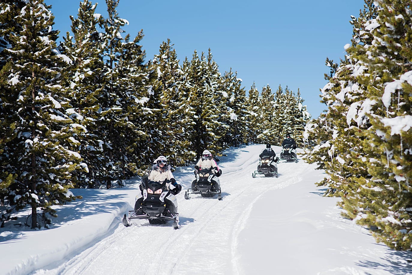 group riding snowmobiles on the way to their breckenridge elopement
